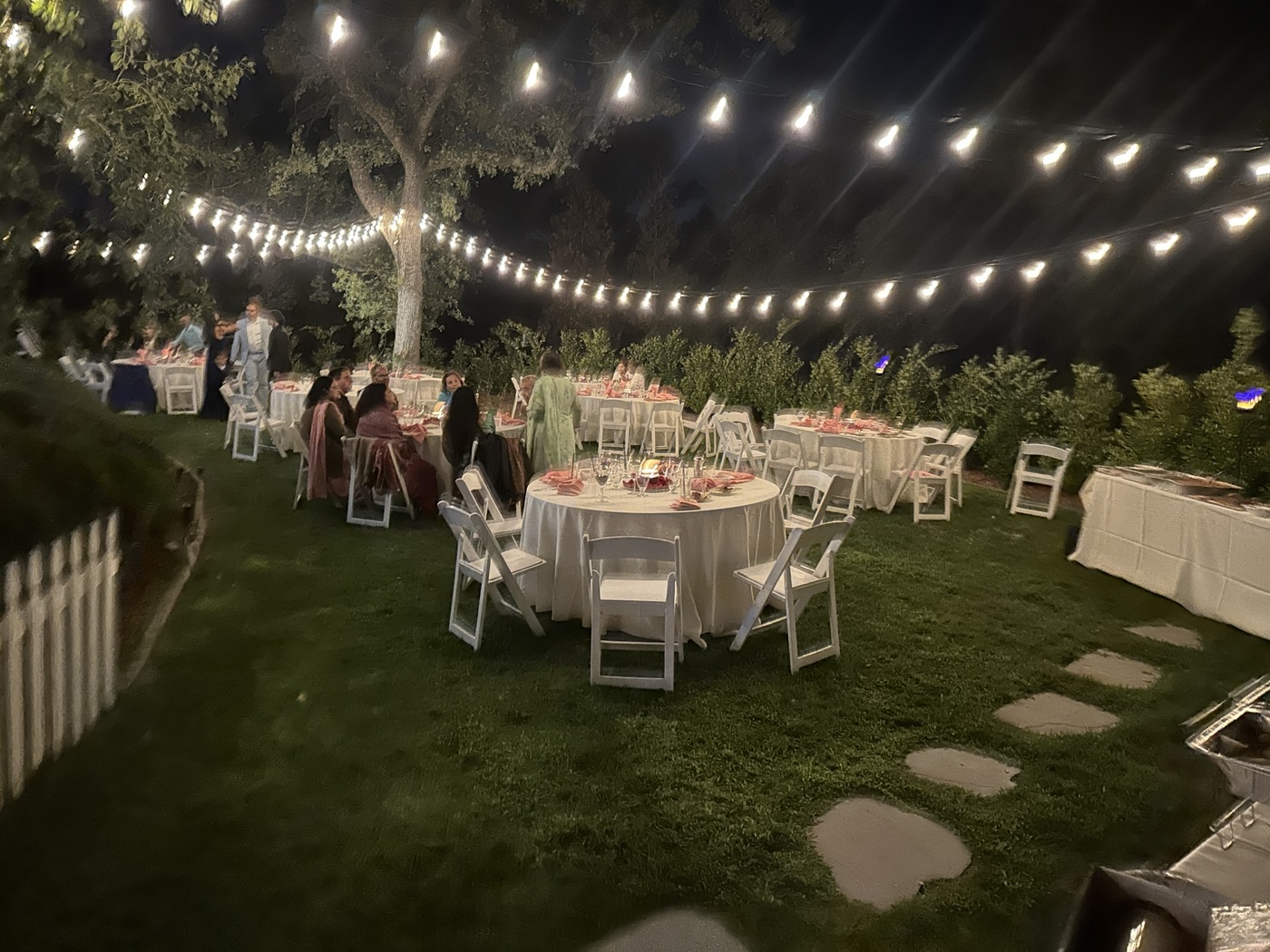 Outdoor dining tables at an Italian Brothers garden celebration